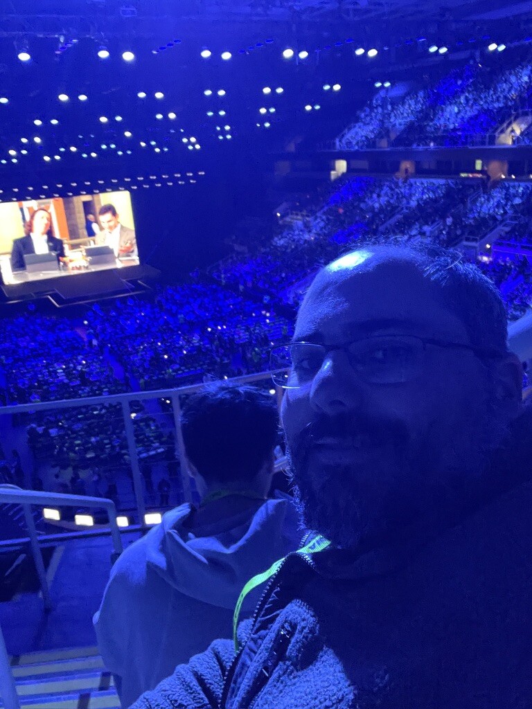Selfie at the keynote with the Acquired podcast on screen